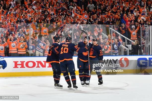 Zach Hyman, Ryan Nugent-Hopkins, Connor McDavid and Tyson Barrie of the Edmonton Oilers celebrate after a goal during Game Four of the Western...