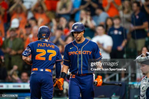 Houston Astros second baseman Jose Altuve hand shakes Houston Astros designated hitter Michael Brantley after hitting a home-run in the 1st inning...