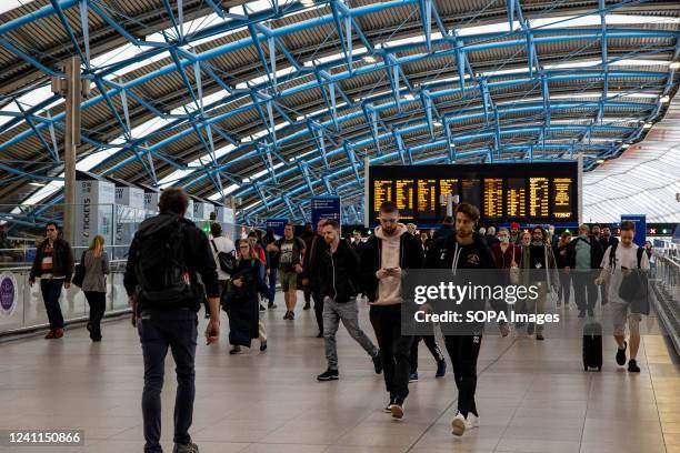 Commuters are in Waterloo Station. Waterloo Station is busier than usual at rush hours due to the London Underground strike. London Underground...