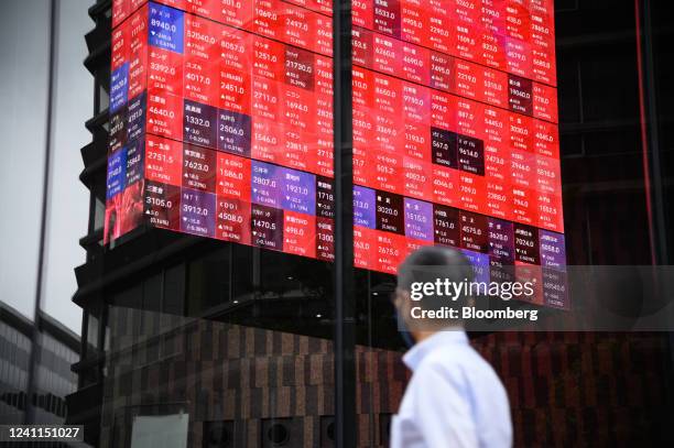 Stock figures on a rotating-cube screen in an atrium of the Kabuto One building, next the Tokyo Stock Exchange, in Tokyo, Japan, on Tuesday, June 7,...