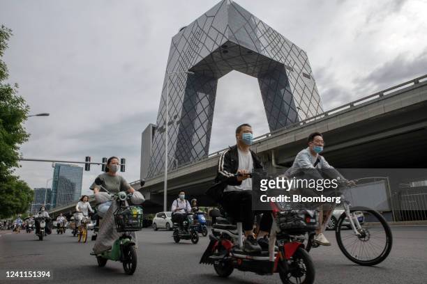 Motorists travel past the China Central Television Tower in Beijing, China, on Tuesday, June 7, 2022. As Beijing relaxes Covid curbs and allows...