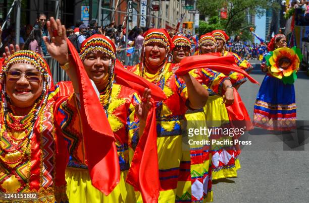 Women are seen dancing with traditional Filipino outfits during the annual Philippine Independence Day Parade.
