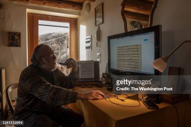 Claudio Ronco renowned cellist, portrayed in front of the screen of the computer on which he works, in the living room of his house in Osigo, a small...