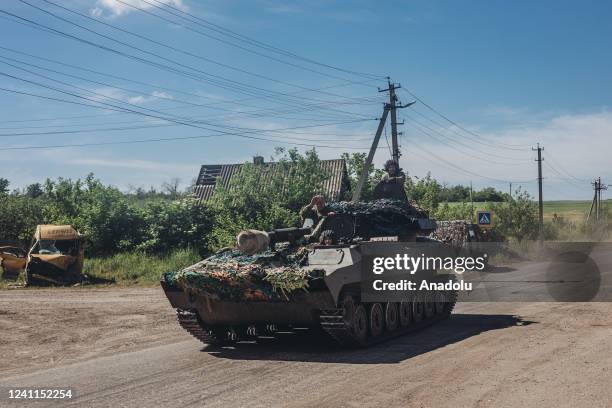 An Ukrainian soldier drives tank on a road in Luhansk, Ukraine on June 6, 2022.