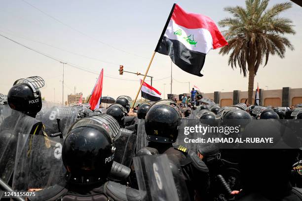 Iraqi security forces deploy to disperse protesters during a demonstration against the governments employment policy near the parliament building in...