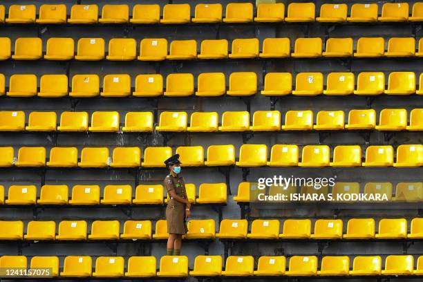 Policewoman guards the spectators' stand before the start of the first Twenty20 international cricket match between Sri Lanka and Australia at the R....