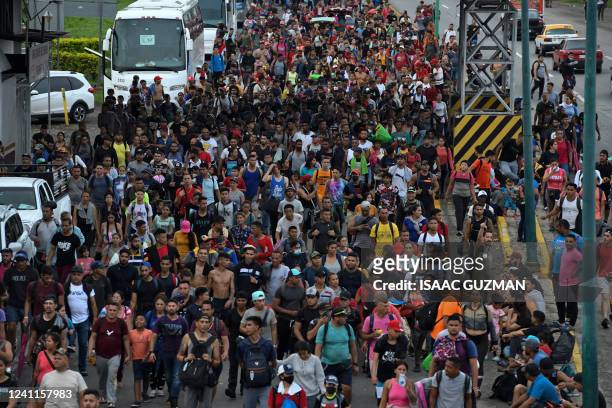 Latin American migrants take part in a caravan towards the border with the United States, in Huehuetan, Chiapas state, Mexico, on June 7, 2022. -...