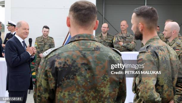 German Chancellor Olaf Scholz speaks with German Bundeswehr soldiers part of the NATO enhanced Forward Presence battlegroup during a visit of the...