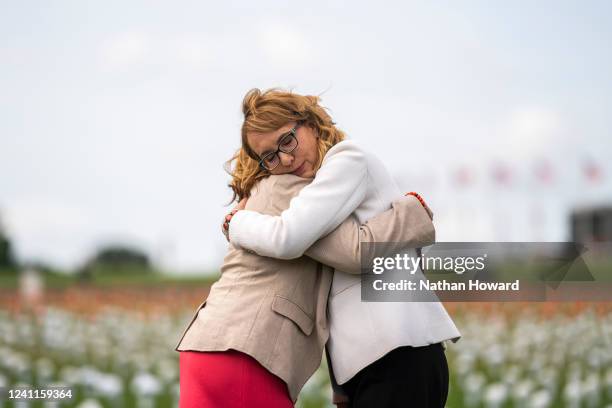 Former Arizona congresswoman Gabby Giffords hugs Rep. Lucy McBath at the Giffords Gun Violence Memorial in front of the Washington Monument on June...