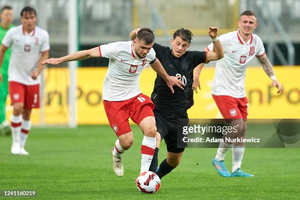 Lukasz Poreba from U21 Poland fights for the ball with Lazar Samardzic from U21 Germany during the UEFA European Under-21 Championship Qualifier...