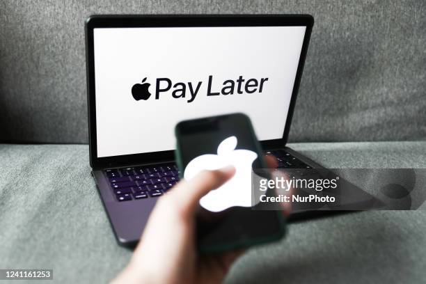 Apple Pay Later logo displayed on a laptop screen and Apple logo displayed on a phone screen are seen in this illustration photo taken in Krakow,...