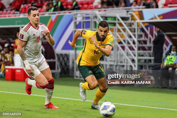 S forward Caio Canedo marks Australia's defender Aziz Behich during the FIFA World Cup 2022 play-off qualifier football match between UAE and...