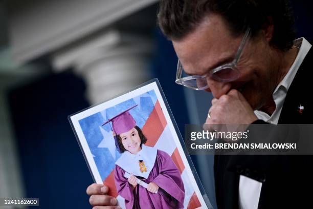 Actor Matthew McConaughey holds a photo of Alithia Ramirez, a 10 year old student who was killed in the mass shooting at Robb Elementary School,...