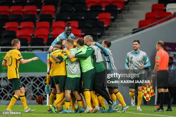 Australia's players celebrate after their second goal during the FIFA World Cup 2022 play-off qualifier football match between UAE and Australia at...