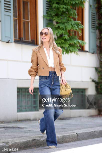 Influencer and model Marlies Pia Pfeifhofer wearing 70s Retro tinted sunglasses by Max Mara, white boxy shirt by Zara, beige golden bold hoops coco...