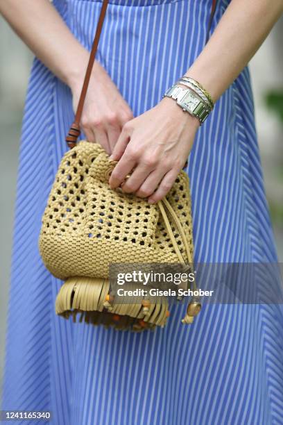 Influencer and model Marlies Pia Pfeifhofer wearing silber Watch Tank by Cartier, beige golden and whitegold bangles Coco Crush by Chanel, raffia...