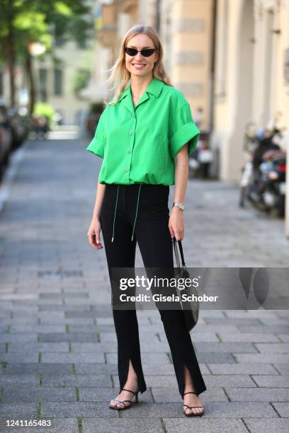 Influencer and model Marlies Pia Pfeifhofer wearing a black cat eye sunglasses Miss Dior Butterfly by Dior, green boxy shirt jacket by Sportmax, high...