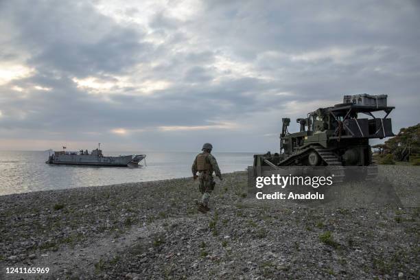 Marine walks in the Tofta military firing range area in the outskirts of Visby, Gotland, during the Baltops 22, the Balticâs year military exercise...