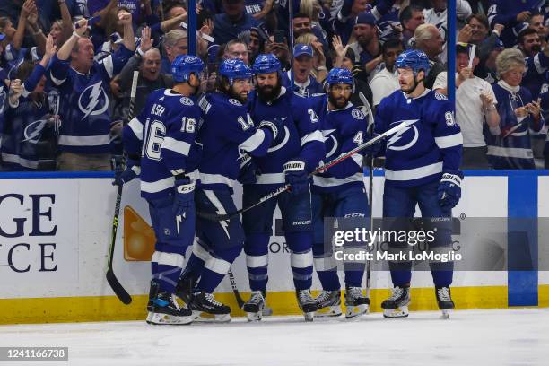 Pat Maroon of the Tampa Bay Lightning celebrates a goal with teammates Riley Nash, Zach Bogosian, Pierre-Edouard Bellemare, and Mikhail Sergachev...