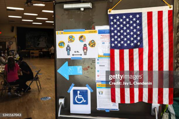 Los Angeles, CA Voting during a time of coronavirus, with safety precautions like signs reminding of social distancing, before entering to cast a...