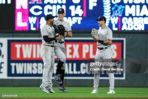 Aaron Hicks, Aaron Judge, and Joey Gallo of the New York Yankees celebrate a 10-4 victory against the Minnesota Twins at Target Field on June 7, 2022...