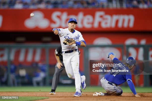 Kansas City Royals second baseman Nicky Lopez turns a double play over Toronto Blue Jays shortstop Bo Bichette during an MLB game on June 7, 2022 at...