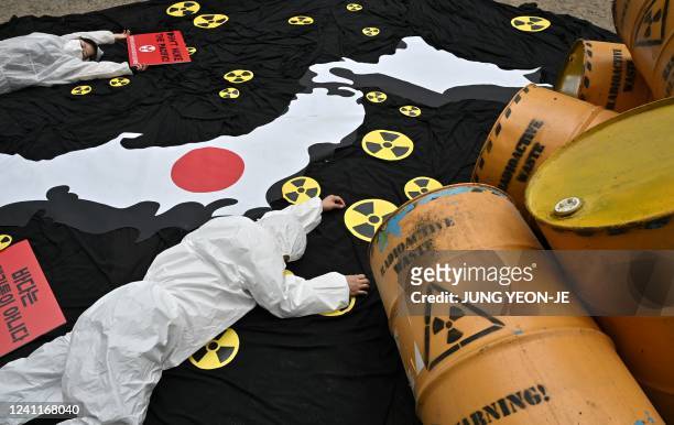 South Korean environmental activists perform during a protest in Seoul against Japan's plan to discharge Fukushima radioactive water into the sea, as...