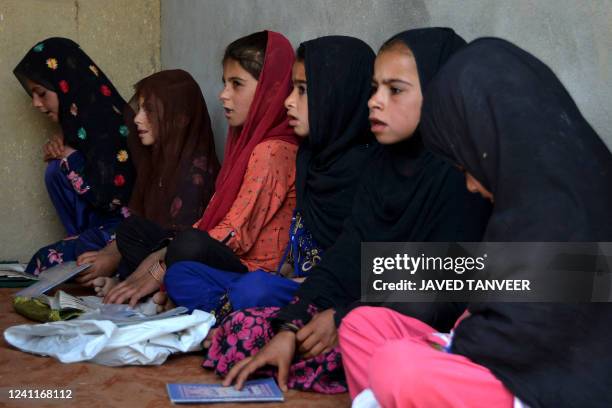 In this photograph taken on June 7 Afghan girls study inside a one-classroom private educational center in Panjwai district of Kandahar.