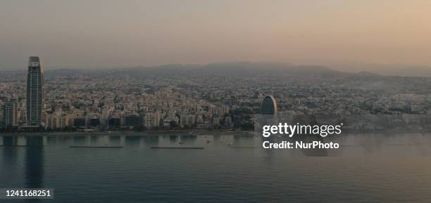 View of the Oval Office Complex, on the right, and the One Tower, on the left, in a light haze at dawn in the Mediterranean port of Limassol. Cyprus,...