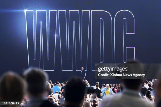 People attend a keynote address event during the 2022 Apple Worldwide Developers Conference WWDC22 at the Apple Park in Cupertino, California, the...