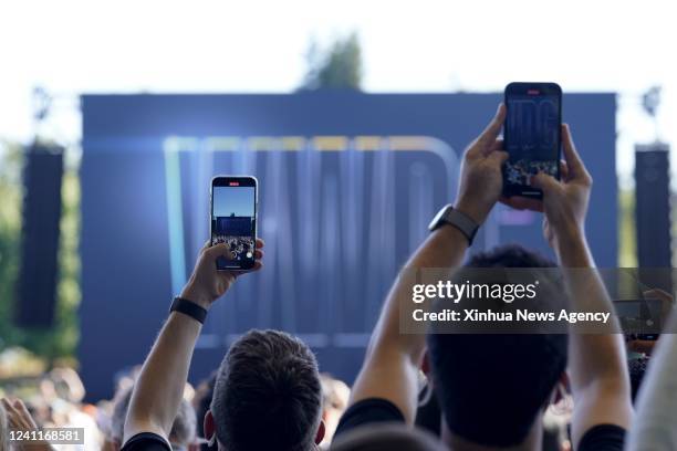 People attend a keynote address event during the 2022 Apple Worldwide Developers Conference WWDC22 at the Apple Park in Cupertino, California, the...
