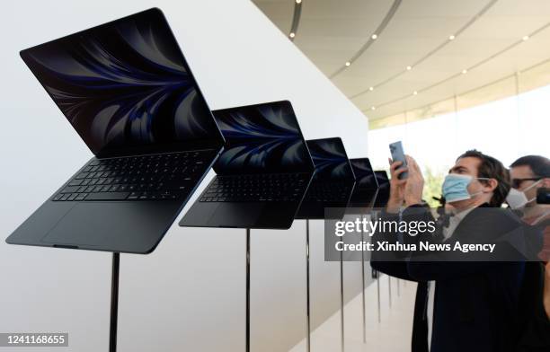 Visitors view new products during the 2022 Apple Worldwide Developers Conference WWDC22 in the Steve Jobs Theater at the Apple Park in Cupertino,...