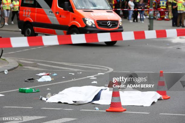 The body of a dead person is seen at a cordoned-off area at the site where a car ploughed into a crowd near Tauentzienstrasse in central Berlin, on...