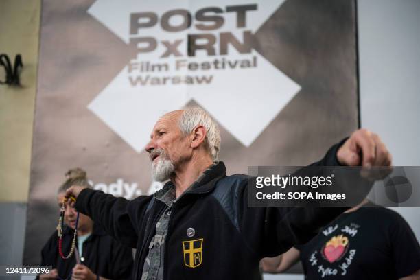 Man with a rosary in his hand prays outside the Muranow cinema. The first porn film festival called Post Porn Film Festival begins in Warsaw on June...