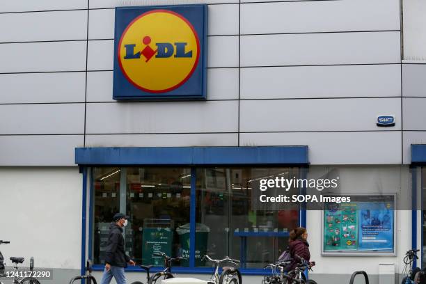 Shoppers walk past the Lidl store in London.