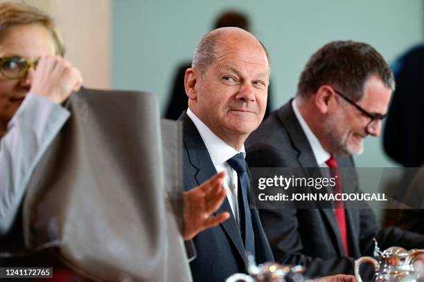 German Chancellor Olaf Scholz looks on next to German Chief of Staff Wolfgang Schmidt as they attend the weekly cabinet meeting at the Chancellery in...