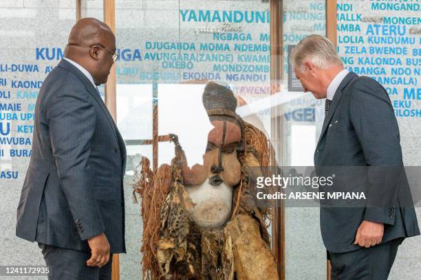 President of the Democratic Republic of the Congo Felix Tshisekedi looks at a ceremonial mask handed over by Belgium's King Philippe at the National...