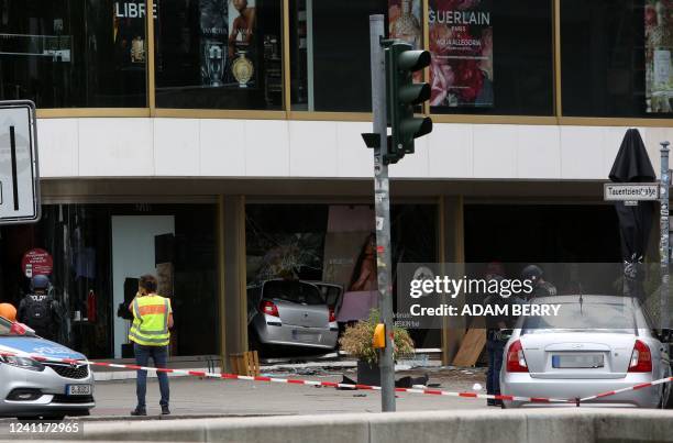 Police block the scene where a car crashed into a crowd and then a shop near Breitscheidplatz killing in central Berlin, on June 8, 2022. - One...