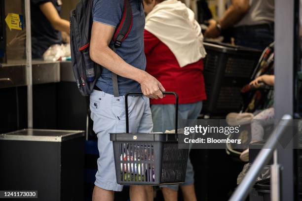 Customer carries a basket of food products inside a Lidl supermarket in Budapest, Hungary, on Tuesday, June 7, 2022. Inflation in Hungary exceeded...