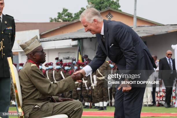 King Philippe - Filip of Belgium greets caporal Kunyuku at a wreath laying at the 'Memorial aux anciens combattants', in Kinshasa, during an official...