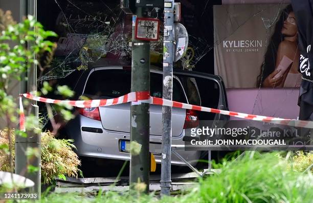 Photo taken on June 8, 2022 shows a car that crashed into a shop window after ploughing into a crowd, at the corner of Tauentzienstrasse and...