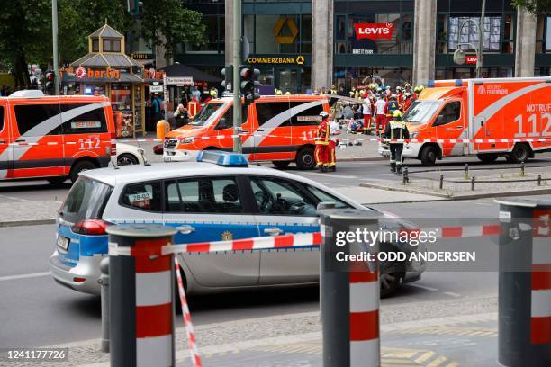 Emergency services, police and ambulance cars are seen at a cordoned-off area at the site where a car ploughed into a crowd at Tauentzienstrasse and...