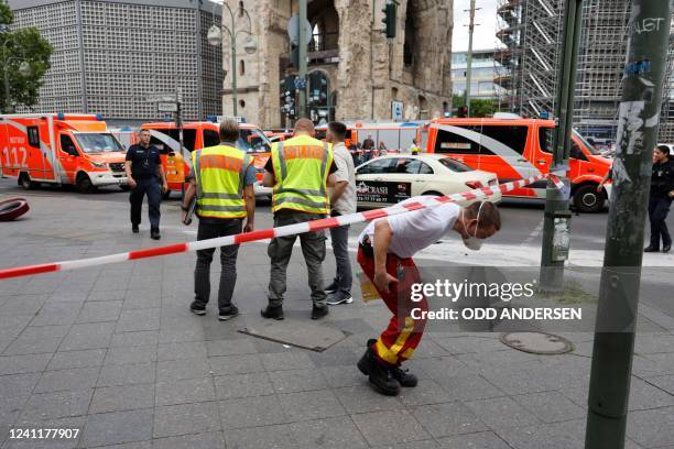 Police officers and emergency services stand opposite the Kaiser Wilhelm Memorial Church at Breitscheidplatz, at the site where a car ploughed into a...