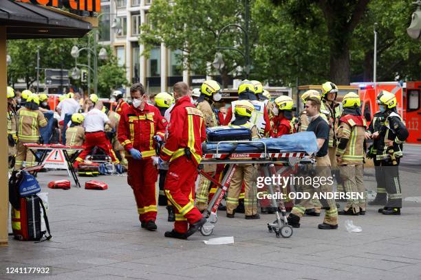 Emergency services move a stretcher at the site where a car ploughed into a crowd at Tauentzienstrasse and Kurfuerstenstrasse in central Berlin, on...