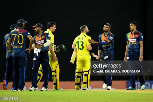 Australia's Matthew Wade and teammate Jhye Richardson shakes hands with Sri Lanka's Captain Dasun Shanaka after Australia won the second Twenty20...