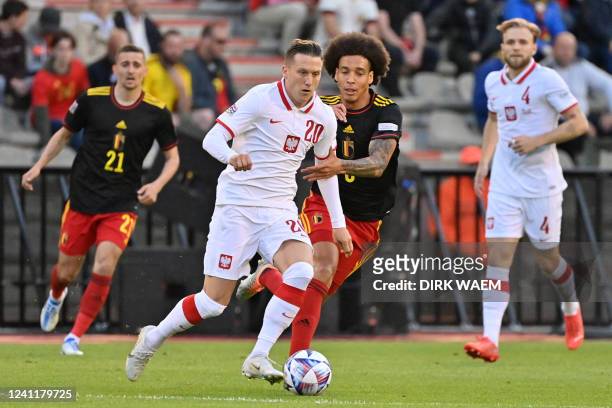 Poland's Piotr Zielinski and Belgium's Axel Witsel fight for the ball during a soccer game between Belgian national team the Red Devils and Poland,...