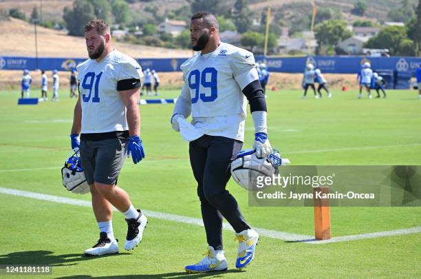 Greg Gaines of the Los Angeles Rams and Aaron Donald talk on the field during mini camp at the team's facility at California Lutheran University on...
