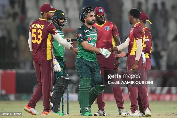 Pakistan's Mohammad Nawaz and teammate Khushdil Shah shake hands with West Indies' players after their victory during the first one-day international...