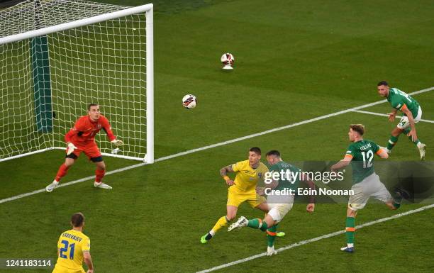 Dublin , Ireland - 8 June 2022; Shane Duffy of Republic of Ireland has a header on goal saved by Ukraine goalkeeper Andriy Lunin during the UEFA...