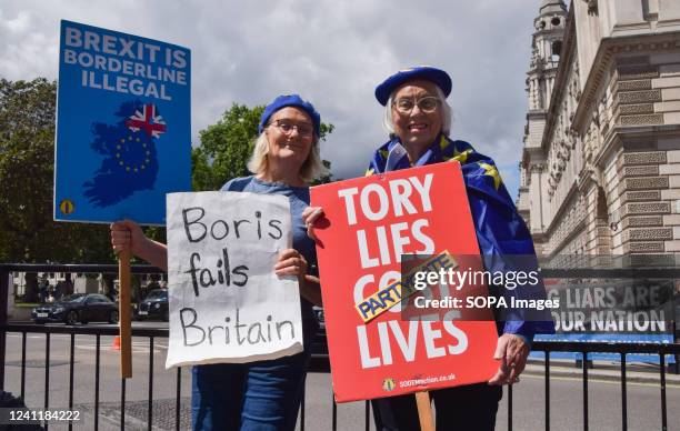 Protesters hold anti-Tory, anti-Brexit and anti-Boris Johnson placards during the demonstration outside the Parliament. Anti-Tory protesters gathered...